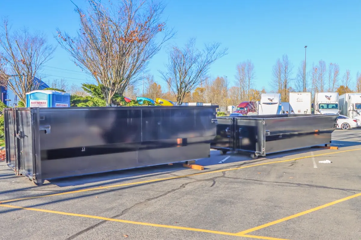 Professional dumpster rental service with roll-off container on residential driveway in Dunkirk